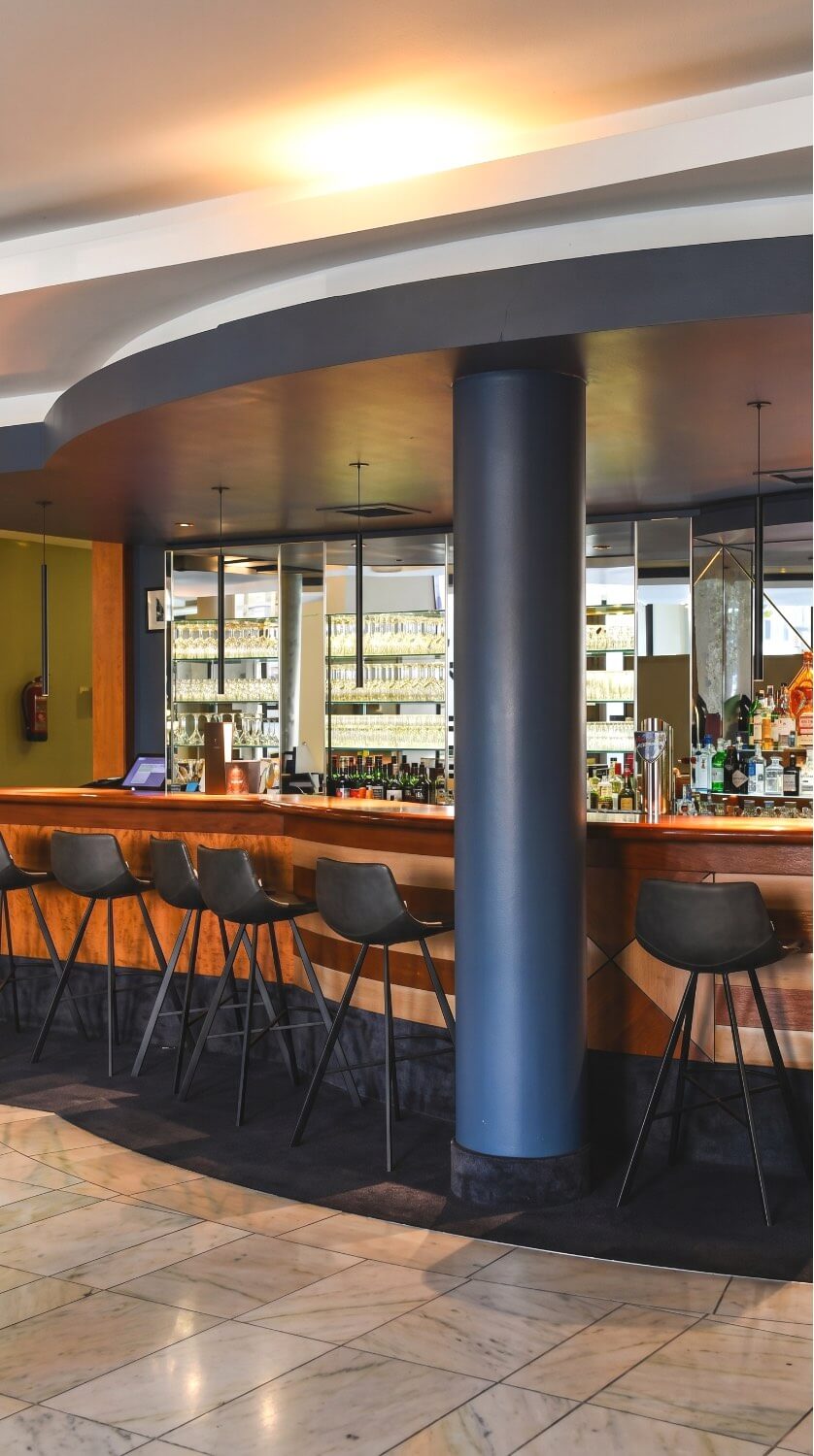 Restaurant and bar area with warm hotel lighting.