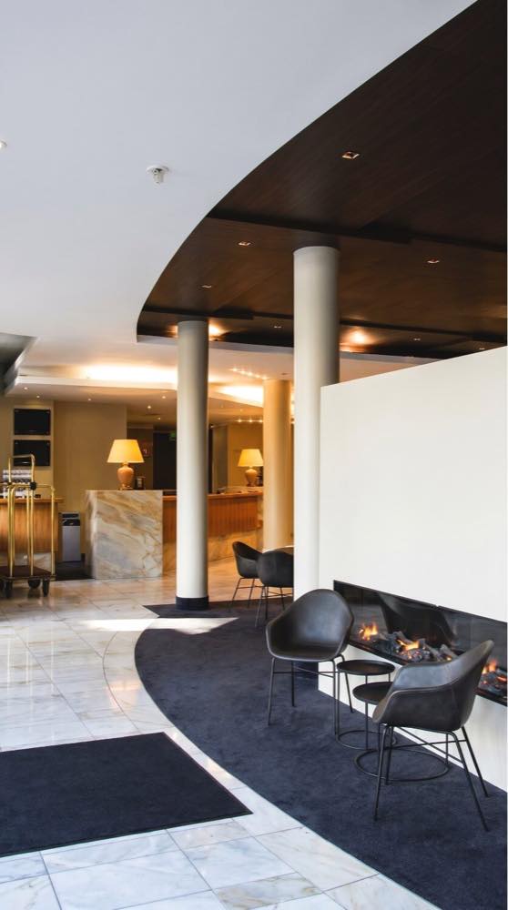 Hotel public area with warm lighting and guest seating.